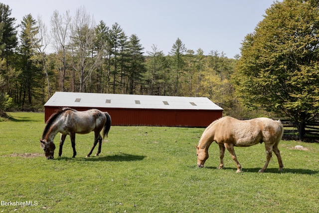 view of horse barn with a rural view