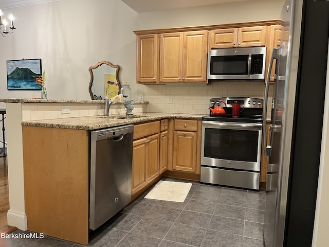 4 Evergreen Trl Unit 4, Lenox, MA 01240 - kitchen featuring appliances with stainless steel finishes, a peninsula, decorative backsplash, and light stone countertops