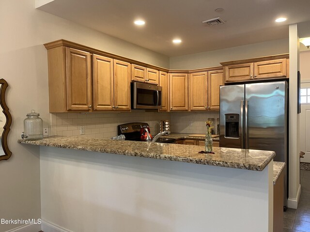 4 Evergreen Trl Unit 4, Lenox, MA 01240 - kitchen featuring stainless steel appliances, decorative backsplash, a peninsula, stone countertops, and recessed lighting
