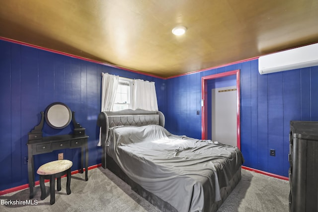 bedroom with carpet flooring, a wall unit AC, and baseboards