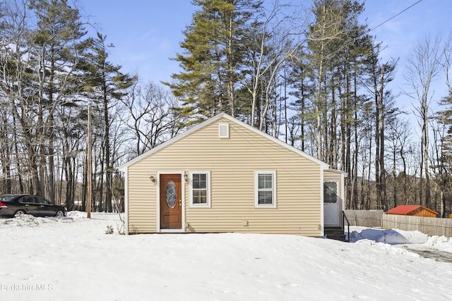 view of front of home featuring entry steps and fence