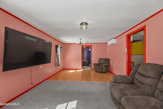 carpeted living room with a wall mounted AC, an inviting chandelier, wood finished floors, and baseboards