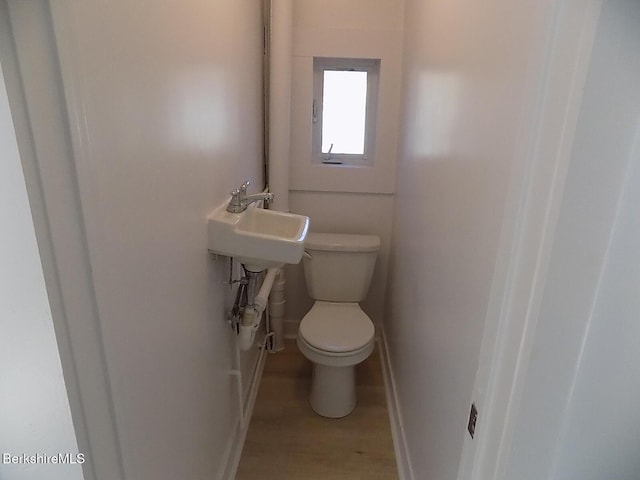 115 Commercial St, Adams, MA 01220 - bathroom featuring baseboards, a sink, wood finished floors, and toilet