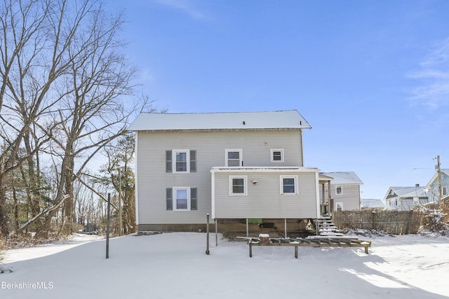 view of snow covered back of property