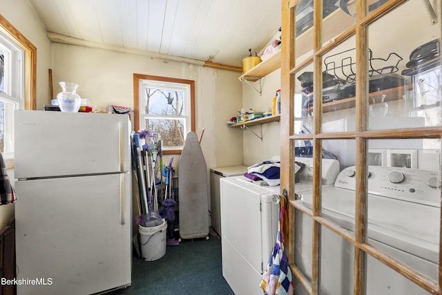 laundry area with washer and clothes dryer and dark carpet