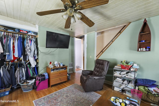 living area featuring hardwood / wood-style floors and wood ceiling