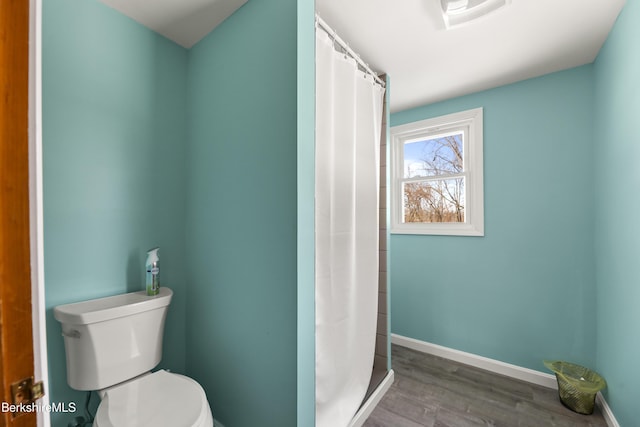 bathroom with hardwood / wood-style flooring, toilet, and a shower with shower curtain