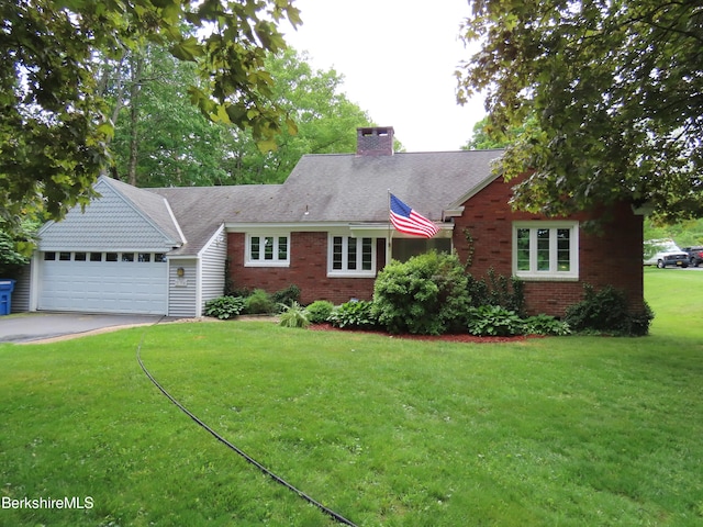 view of front of property featuring a garage and a front yard