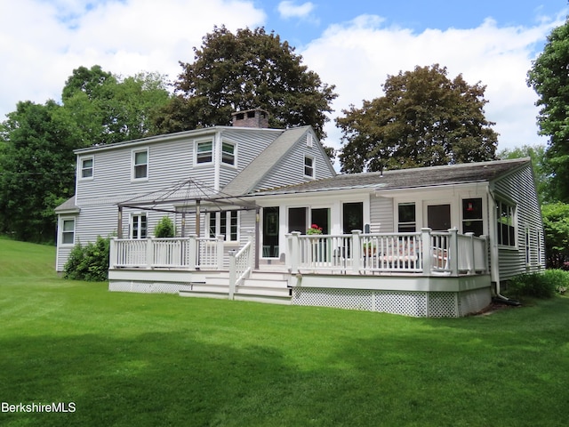 back of property featuring a gazebo, a yard, and a wooden deck