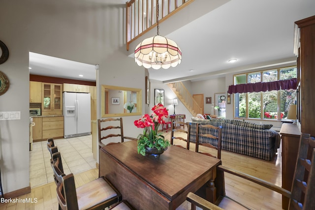 83 Hancock Rd, Pittsfield, MA 01201 - dining space featuring stairway, light wood finished floors, a chandelier, recessed lighting, and a towering ceiling