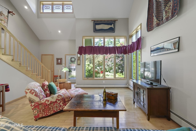 83 Hancock Rd, Pittsfield, MA 01201 - living area featuring a towering ceiling, a baseboard heating unit, light wood-style flooring, stairway, and recessed lighting