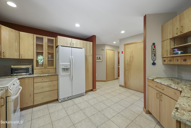 83 Hancock Rd, Pittsfield, MA 01201 - kitchen featuring white appliances, light brown cabinetry, glass insert cabinets, recessed lighting, and light stone countertops