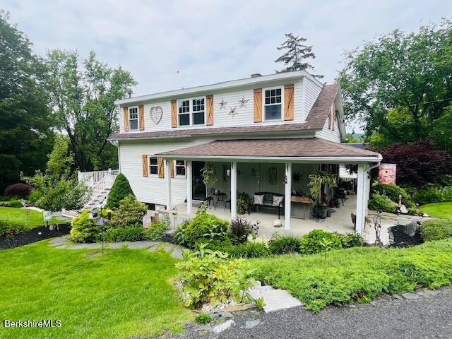 60 Summer St, Lanesborough, MA 01237 - view of front of property with a front lawn, a patio, and a shingled roof