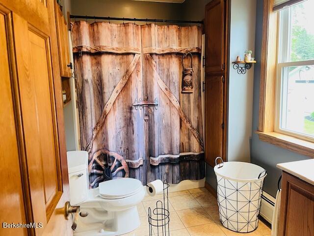 60 Summer St, Lanesborough, MA 01237 - full bath featuring a baseboard heating unit, plenty of natural light, vanity, and tile patterned flooring