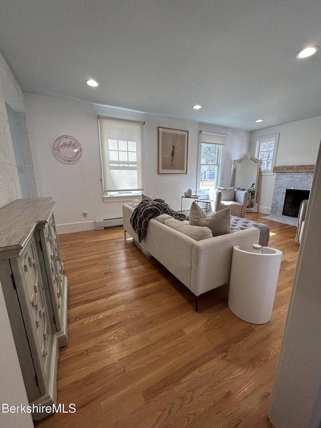 26 Manville St, Great Barrington, MA 01230 - living room with a baseboard heating unit, light wood-type flooring, baseboards, recessed lighting, and a fireplace with flush hearth