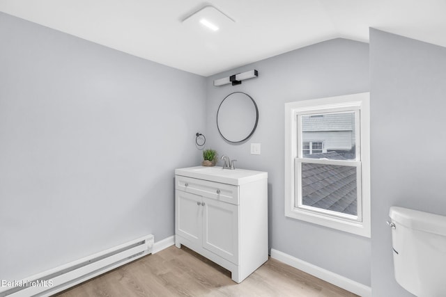 90 Maple St, Lee, MA 01238 - bathroom with a baseboard heating unit, wood finished floors, toilet, vanity, and baseboards