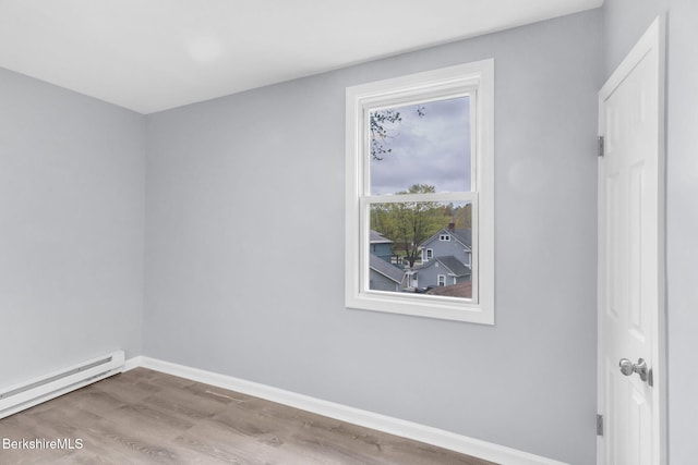 90 Maple St, Lee, MA 01238 - spare room with a baseboard radiator, baseboards, and wood finished floors