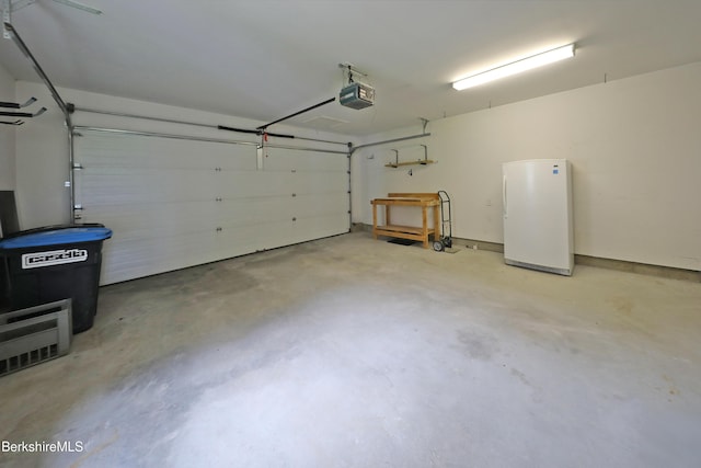 33 Alpine Trl, Pittsfield, MA 01201 - garage with freestanding refrigerator and a garage door opener