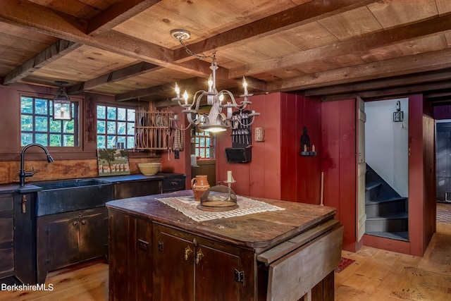 196 S St, Williamstown, MA 01267 - kitchen with a wood ceiling with exposed beams, light wood-type flooring, a chandelier, dark countertops, and a kitchen island