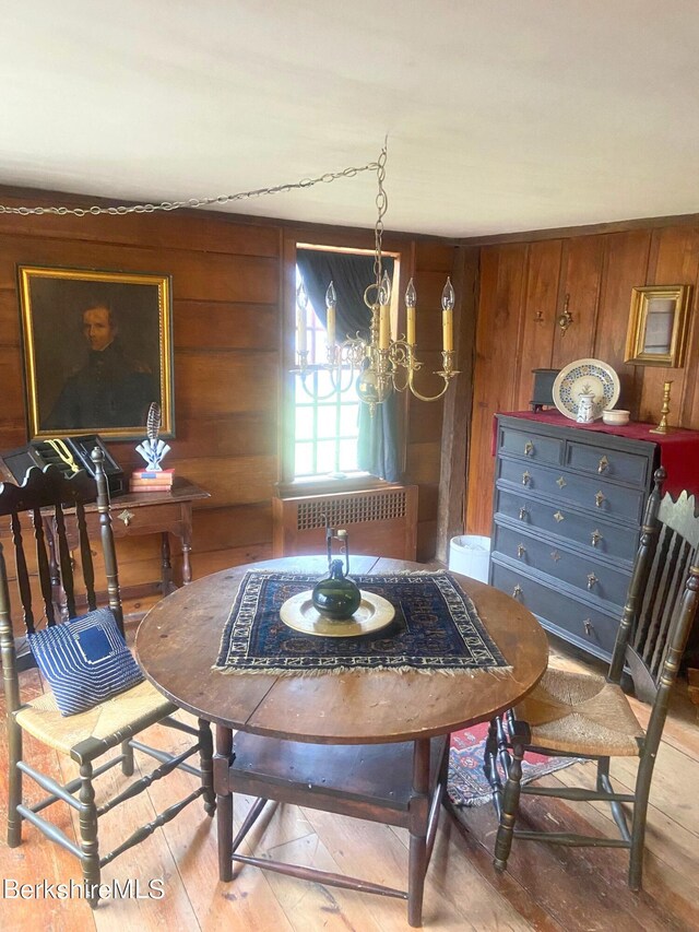 196 S St, Williamstown, MA 01267 - dining space featuring radiator heating unit, hardwood / wood-style floors, wood walls, and a chandelier
