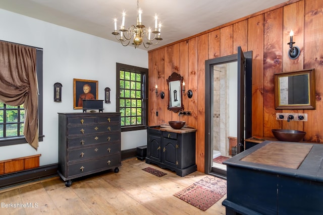 196 S St, Williamstown, MA 01267 - bedroom with a chandelier, light wood-style floors, and wood walls