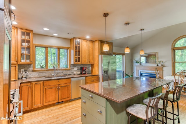 477 Greylock St, Lee, MA 01238 - kitchen featuring stainless steel appliances, light wood finished floors, a sink, brown cabinets, and vaulted ceiling