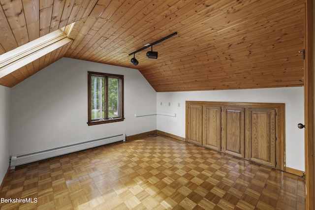 additional living space with baseboard heating, baseboards, vaulted ceiling, and wood ceiling