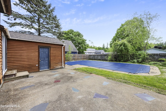 view of swimming pool featuring a fenced backyard and a patio area