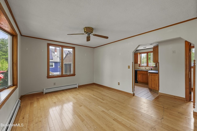 empty room featuring baseboard heating, light wood-style flooring, a ceiling fan, crown molding, and a textured ceiling