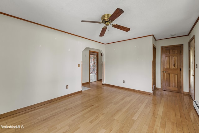 unfurnished room with arched walkways, light wood-style flooring, baseboards, and crown molding