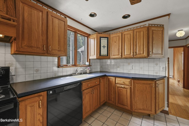 kitchen featuring black appliances, dark countertops, ornamental molding, brown cabinets, and a sink