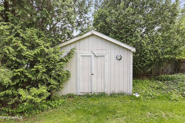 view of shed with fence