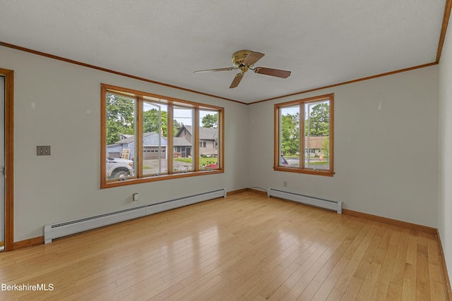 unfurnished room featuring baseboard heating, plenty of natural light, crown molding, and ceiling fan