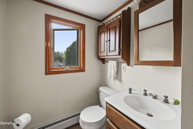 half bath with a baseboard radiator, toilet, vanity, and ornamental molding