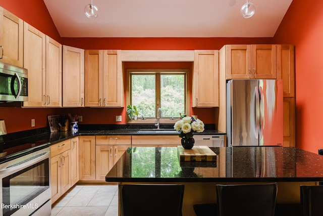 126 Christian Hill Rd, Great Barrington, MA 01230 - kitchen with stainless steel appliances, vaulted ceiling, dark stone countertops, light tile patterned flooring, and light brown cabinetry