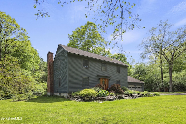 126 Christian Hill Rd, Great Barrington, MA 01230 - rear view of house featuring a chimney, a lawn, and a garage