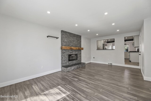 404 N St, Williamstown, MA 01267 - unfurnished living room featuring baseboards, a fireplace, recessed lighting, and dark wood-style floors