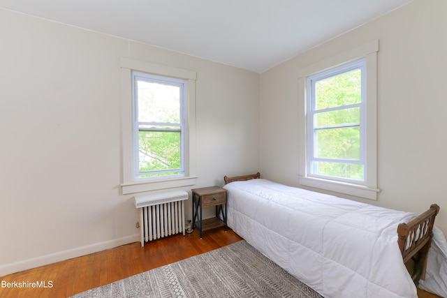 800 Simonds Rd, Williamstown, MA 01267 - bedroom featuring radiator heating unit, multiple windows, and wood finished floors