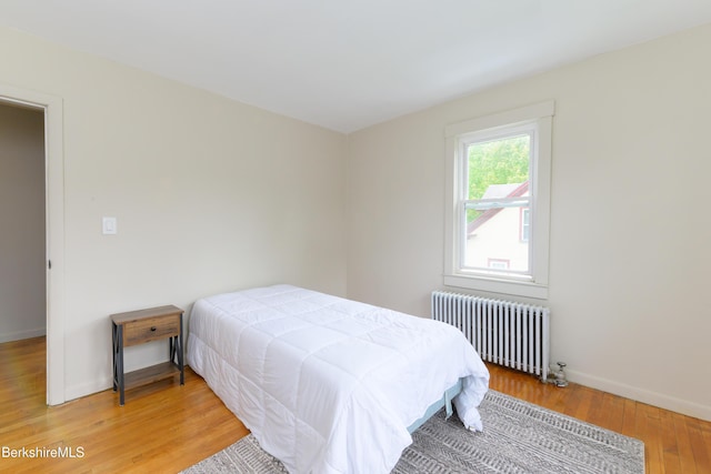 800 Simonds Rd, Williamstown, MA 01267 - bedroom with radiator heating unit, light wood-style flooring, and baseboards