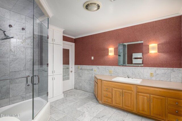 full bath featuring visible vents, tile walls, ornamental molding, marble finish floor, and vanity