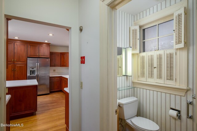 bathroom with recessed lighting, toilet, and wood finished floors