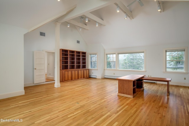 interior space featuring light wood-style floors, a healthy amount of sunlight, visible vents, and a baseboard radiator