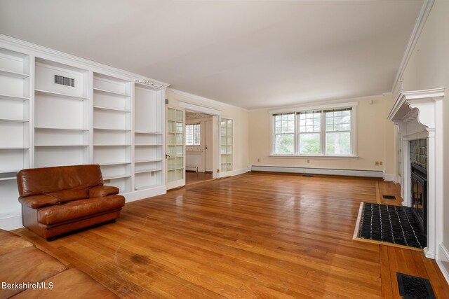 unfurnished living room featuring visible vents, a fireplace, crown molding, and a baseboard radiator