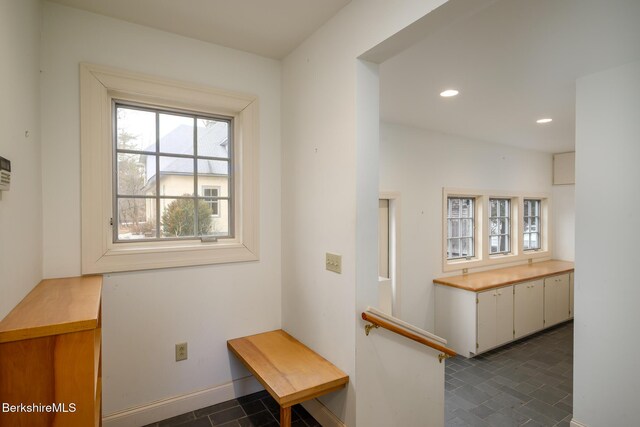 corridor with recessed lighting and baseboards