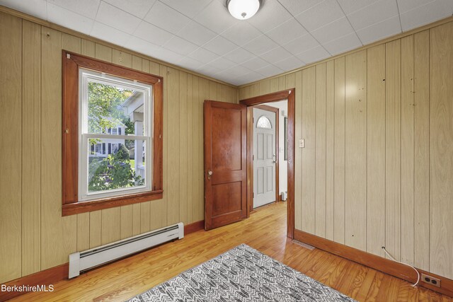 41 Pine St, Dalton, MA 01226 - foyer featuring a baseboard heating unit, light wood-style flooring, and wood walls