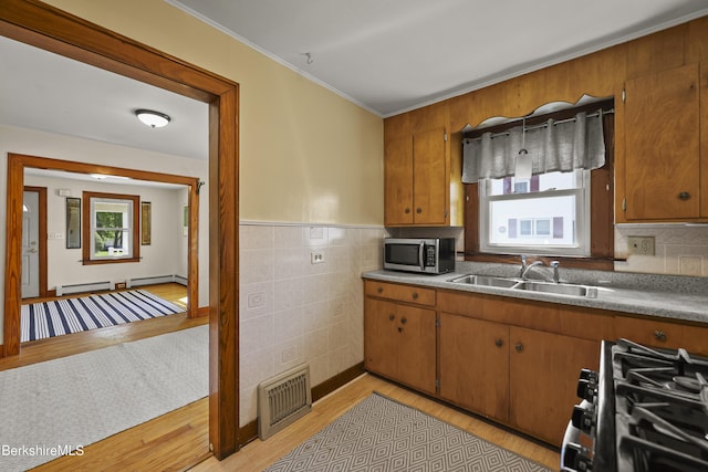 41 Pine St, Dalton, MA 01226 - kitchen featuring stainless steel microwave, range with gas stovetop, a sink, brown cabinets, and light wood-style flooring