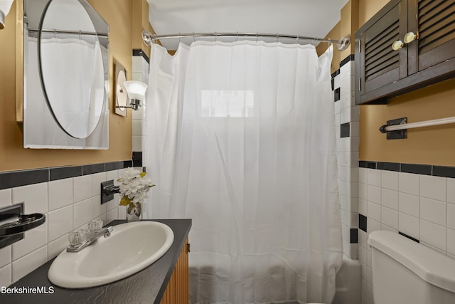 41 Pine St, Dalton, MA 01226 - full bath with tile walls, toilet, vanity, shower / tub combo with curtain, and a wainscoted wall