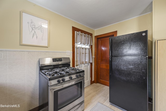 41 Pine St, Dalton, MA 01226 - kitchen with freestanding refrigerator, gas stove, light wood-style flooring, and ornamental molding