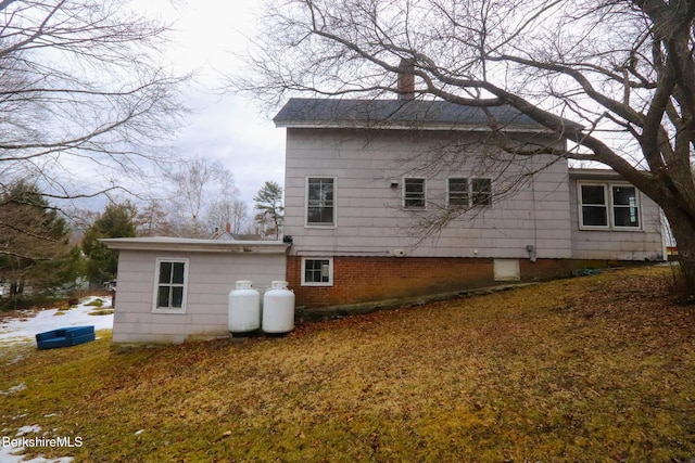 rear view of house featuring brick siding