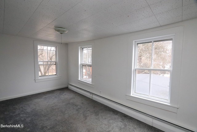 empty room featuring carpet flooring, baseboards, and a baseboard radiator